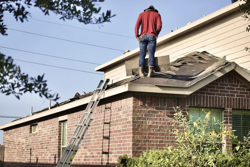 Professional roofer working on a residential roof in Diamond
